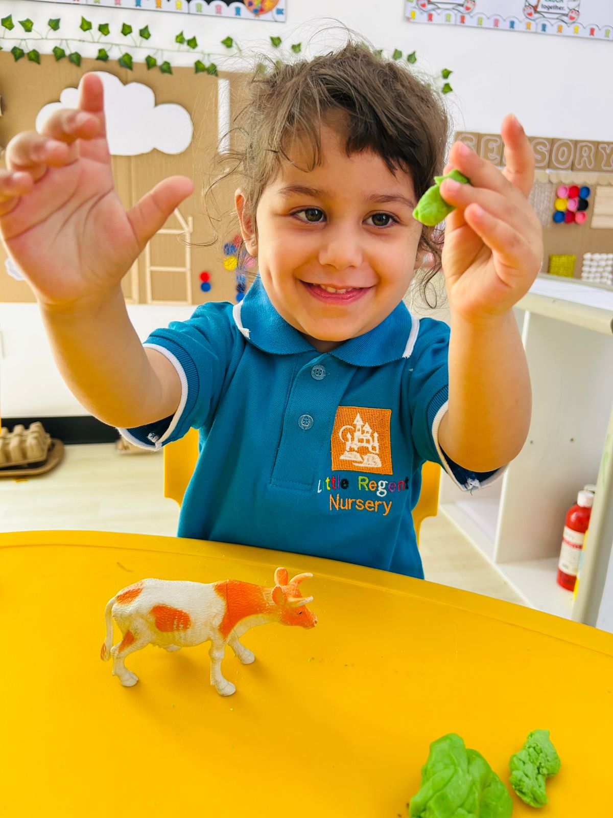 A Tiny Tot exploring with wooden blocks at Little Regent Nursery